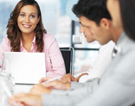 Women Smiling around conference table - Suicom Collaboration